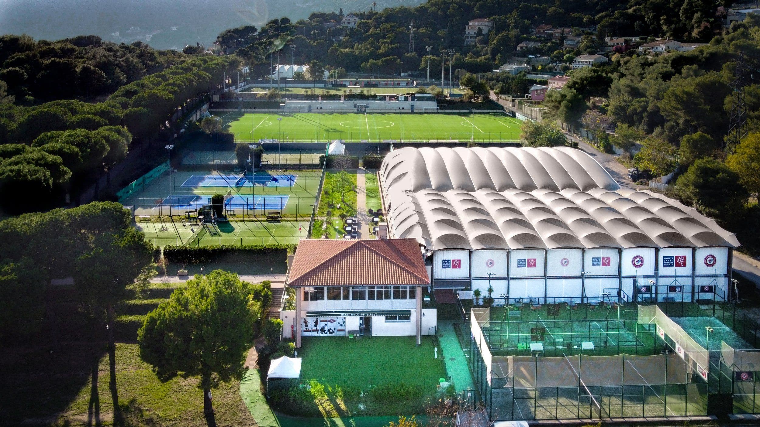 Aerial view of Tennis Padel Soleil with courts and greenery.